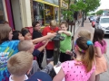 Children touching sculpture